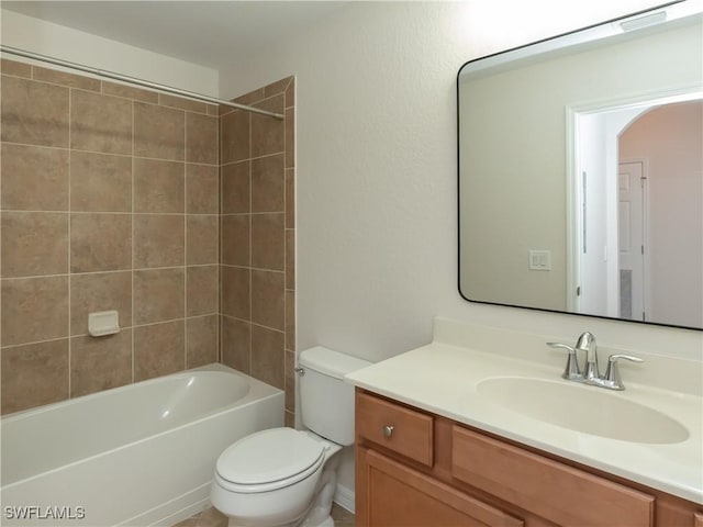 full bathroom with vanity, toilet, and tiled shower / bath combo