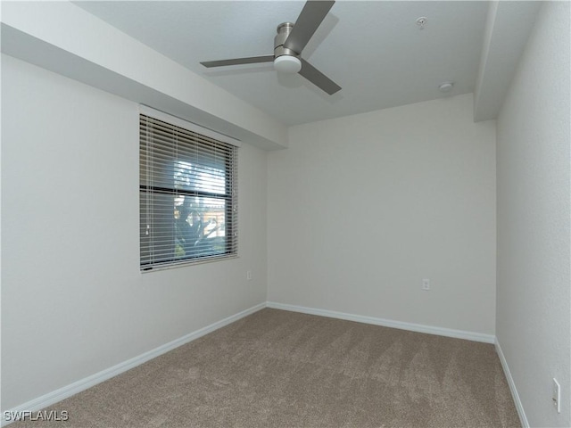 carpeted empty room featuring ceiling fan