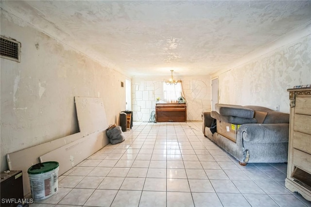 unfurnished living room featuring a notable chandelier and light tile patterned floors