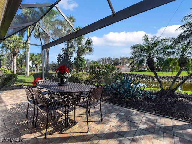 view of patio with a water view and glass enclosure