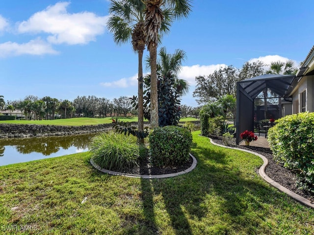 view of yard featuring a water view and glass enclosure