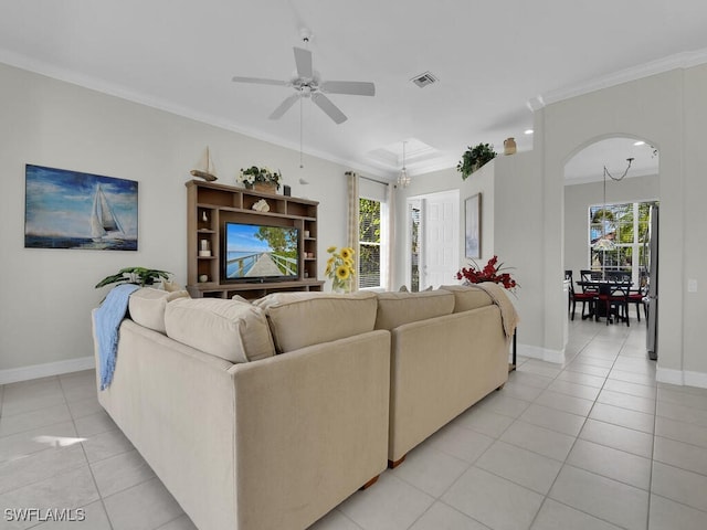 tiled living room with crown molding, plenty of natural light, and ceiling fan