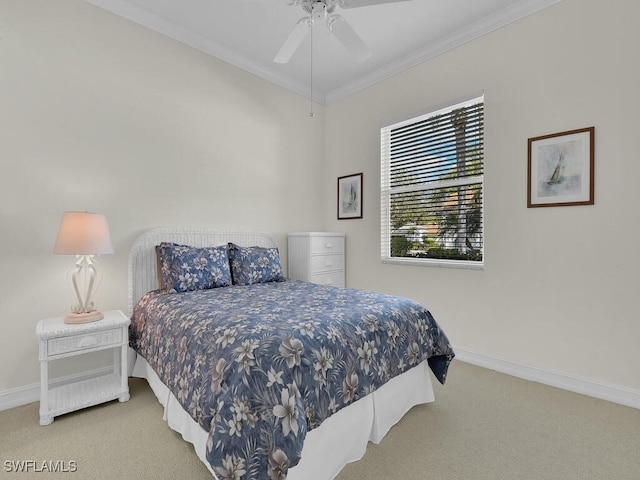 carpeted bedroom featuring ornamental molding and ceiling fan