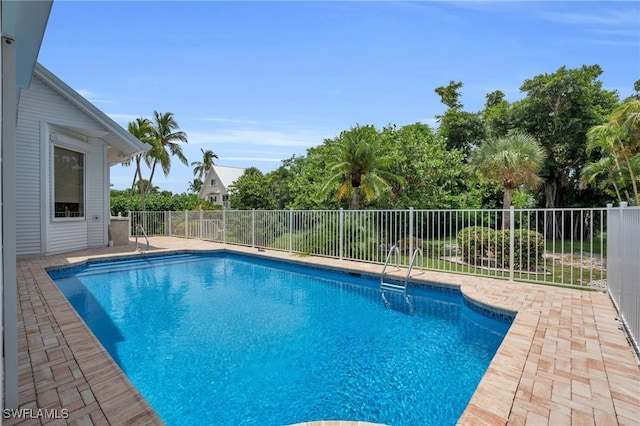 view of swimming pool featuring a patio area, fence, and a fenced in pool