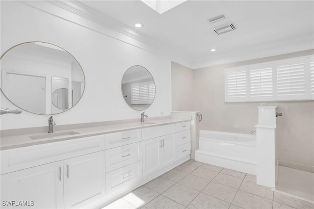 bathroom with tile patterned floors, double vanity, a sink, and a bath