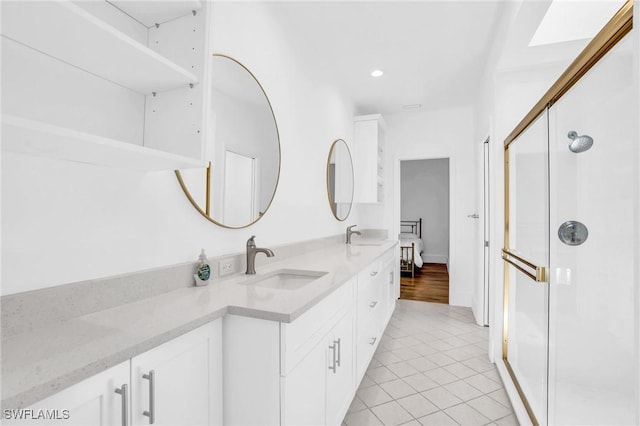 bathroom with recessed lighting, a stall shower, tile patterned flooring, and vanity