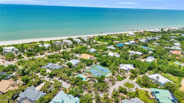 drone / aerial view with a water view, a residential view, and a view of the beach