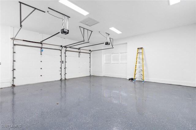 4090 W Gulf Dr, Sanibel, FL 33957 - garage with baseboards and a garage door opener