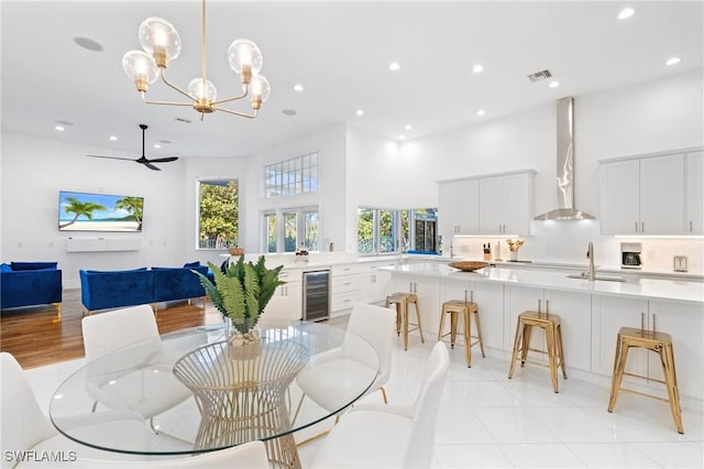 4090 W Gulf Dr, Sanibel, FL 33957 - dining space featuring a wealth of natural light, visible vents, beverage cooler, and a towering ceiling