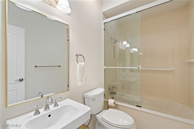 4090 W Gulf Dr, Sanibel, FL 33957 - full bathroom featuring toilet, combined bath / shower with glass door, and a sink