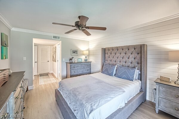 bedroom featuring crown molding, ceiling fan, and light hardwood / wood-style flooring