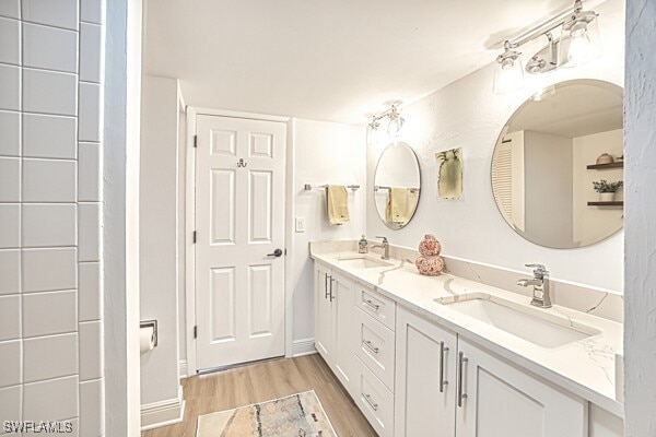 bathroom with vanity and hardwood / wood-style floors