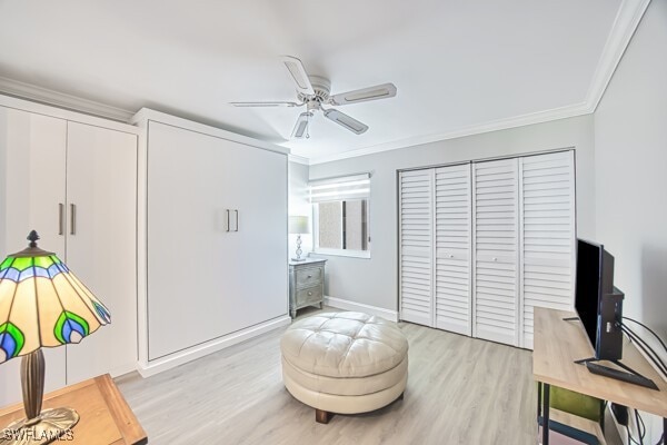 home office with ornamental molding, ceiling fan, and light hardwood / wood-style floors