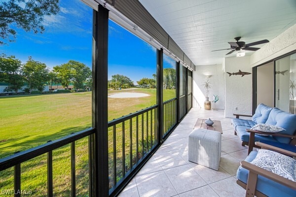 sunroom / solarium featuring ceiling fan