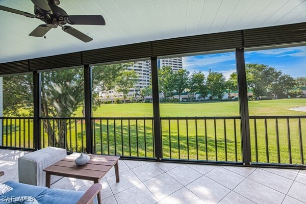 unfurnished sunroom with ceiling fan