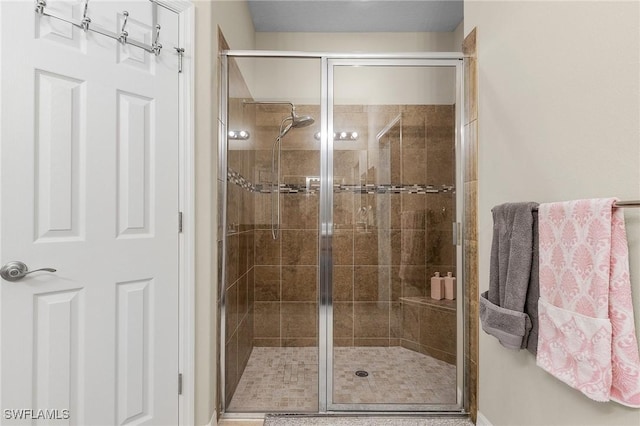 bathroom with a shower with door