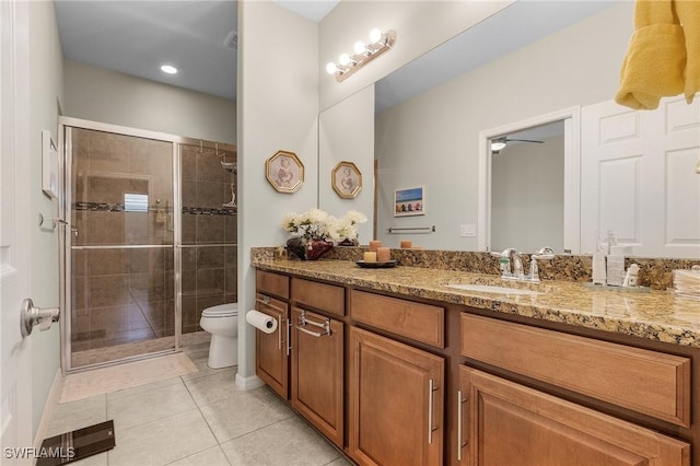 bathroom featuring vanity, tile patterned flooring, toilet, and walk in shower