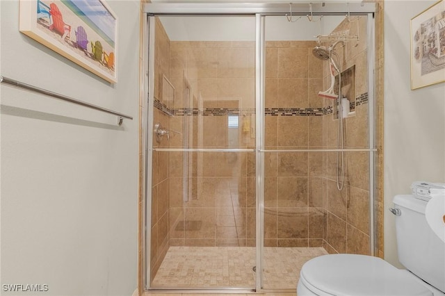 bathroom with an enclosed shower and toilet