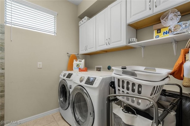 washroom with cabinets, light tile patterned flooring, and independent washer and dryer