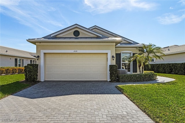 ranch-style home with a garage and a front lawn