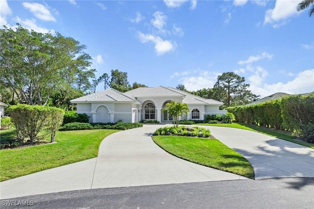 mediterranean / spanish-style house with a front yard