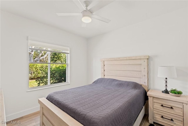 bedroom with ceiling fan and light hardwood / wood-style floors