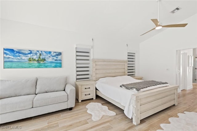 bedroom featuring lofted ceiling, ceiling fan, and light wood-type flooring