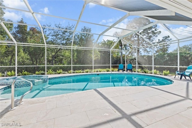 view of pool with glass enclosure and a patio area