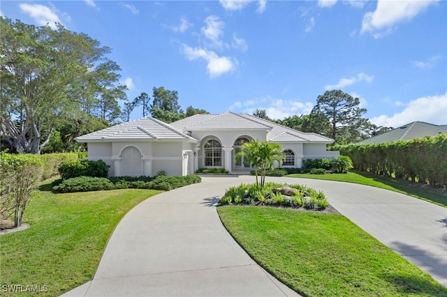 mediterranean / spanish house featuring a front yard