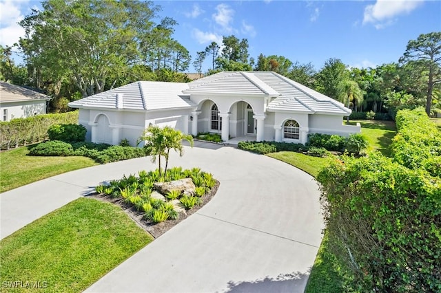 view of front of property with a garage and a front yard