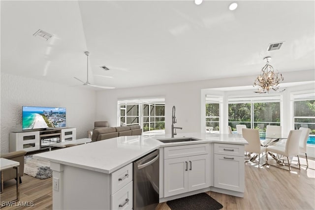 kitchen with sink, light hardwood / wood-style flooring, stainless steel dishwasher, an island with sink, and white cabinets