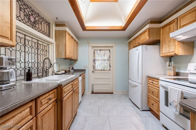 kitchen featuring tasteful backsplash, white appliances, and sink