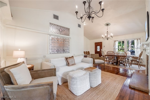 living room with wood-type flooring, a notable chandelier, and high vaulted ceiling