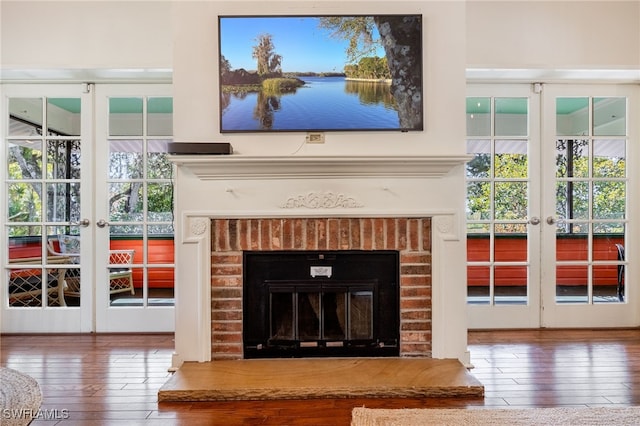 room details with hardwood / wood-style floors, a fireplace, and french doors