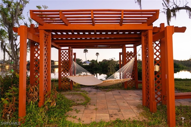 view of patio / terrace featuring a water view and a pergola