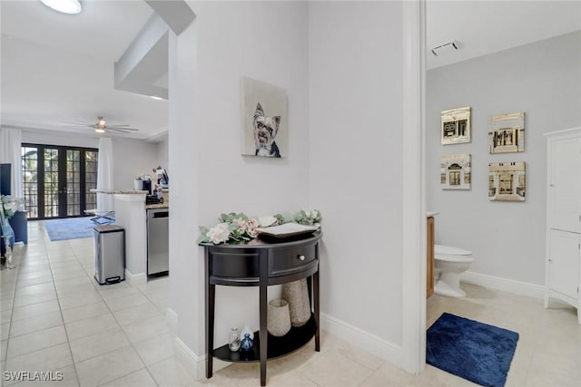 hallway with french doors and light tile patterned floors