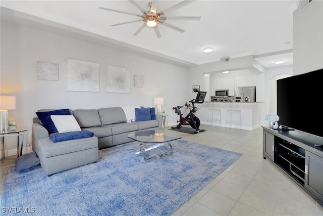 tiled living room with ceiling fan