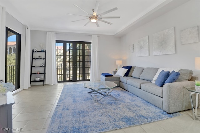 living room with french doors, ceiling fan, and light tile patterned floors