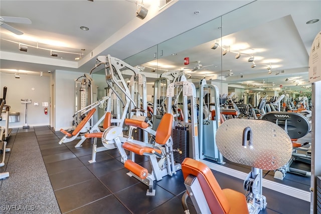 workout area with ceiling fan and track lighting