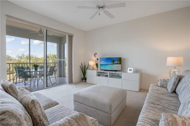 carpeted living room with ceiling fan