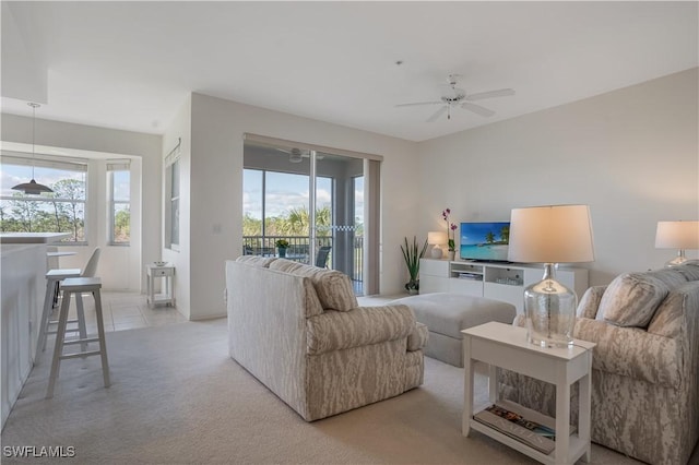 living room featuring a wealth of natural light, light colored carpet, and ceiling fan