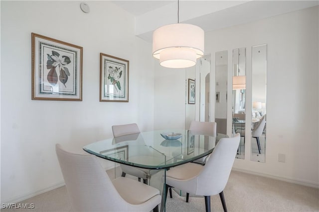 dining area featuring light colored carpet