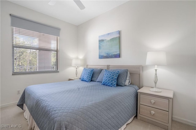 bedroom with light carpet and ceiling fan