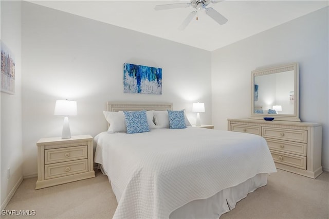 bedroom with ceiling fan and light colored carpet