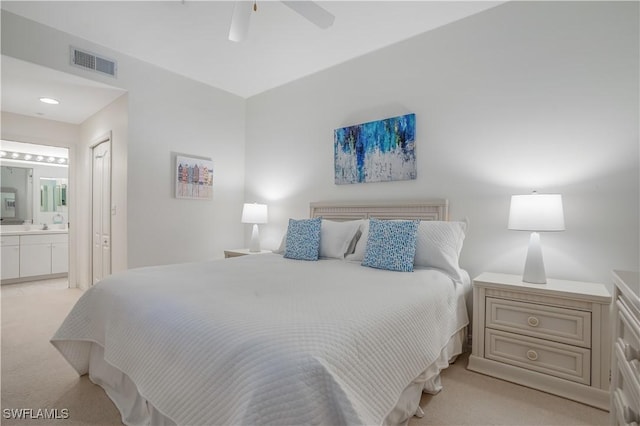 carpeted bedroom featuring ceiling fan and ensuite bathroom