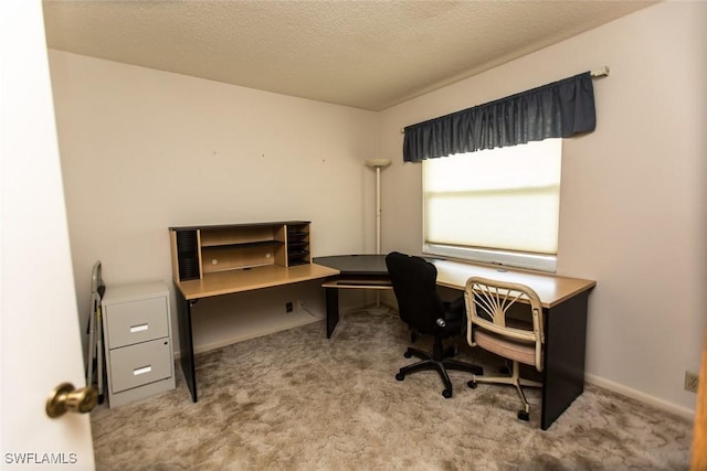 carpeted office space featuring a textured ceiling