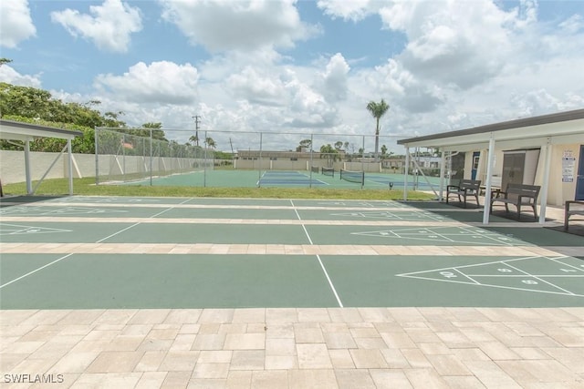 view of home's community with tennis court