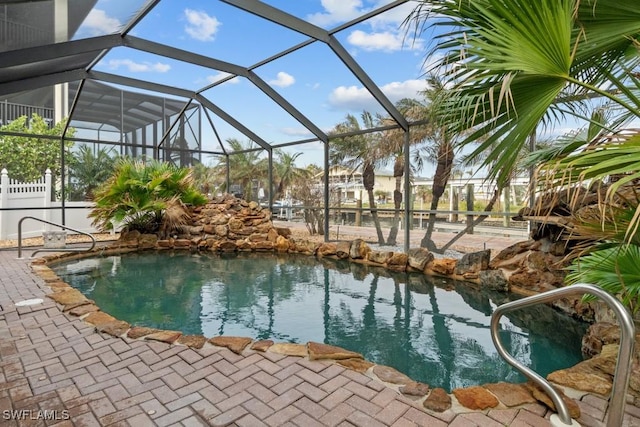 view of swimming pool featuring a lanai