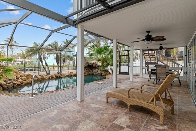 view of patio / terrace with ceiling fan and glass enclosure