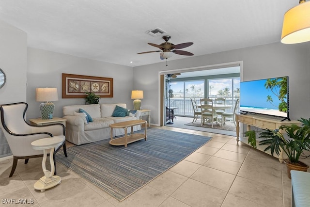 living room with ceiling fan and light tile patterned floors